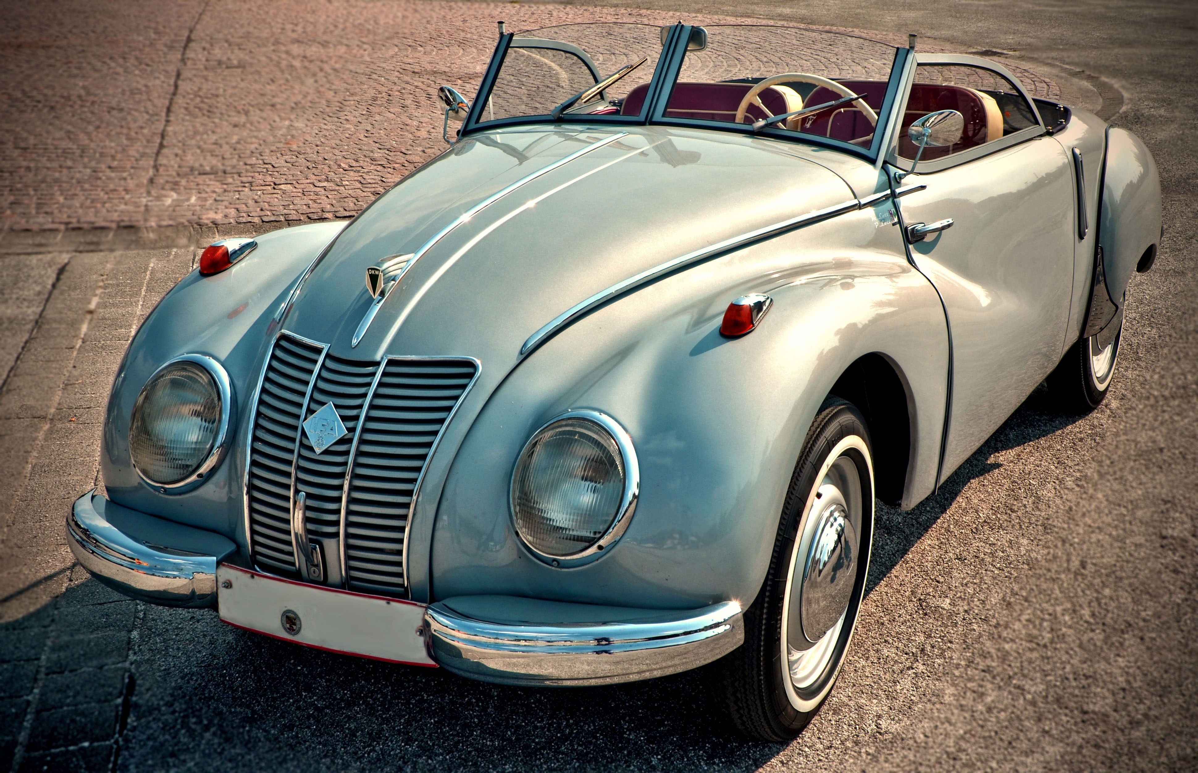 A picture of a silver antique car I fully restored.